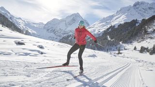 A woman cross country skiing in the Alps