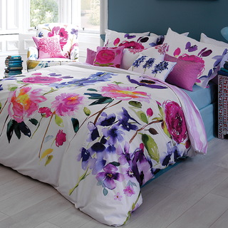 bedroom with wooden flooring and floral printed white bedding set on bed