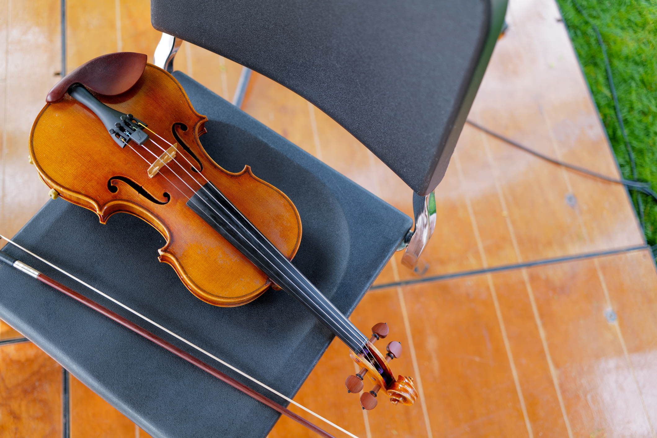 violin and bow on a chair on stage