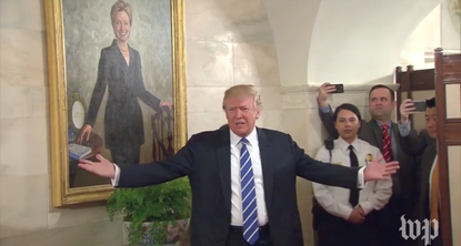 President Trump was photobombed by a portrait of Hillary Clinton.