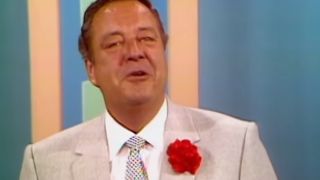 Jackie Gleason smiling with a rose on his suit in The Jackie Gleason Show