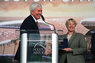 George Nield, FAA associate administrator for commercial space transportation, presents Houston's Mayor Annise Parker with the launch license establishing Houston Spaceport at Ellington Airport, June 30, 2015.