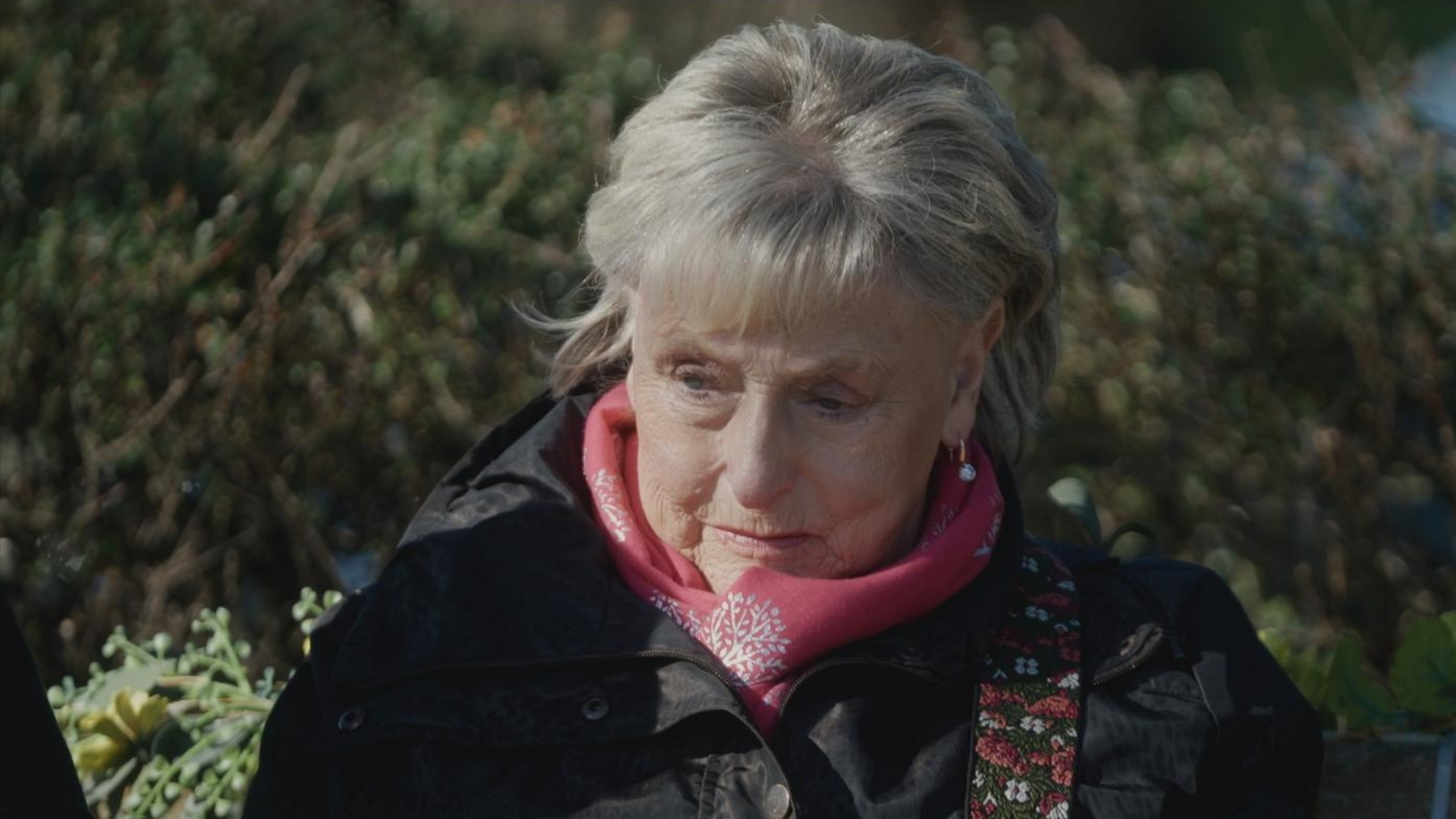 I Fought the Law: The Ann Ming Story - Ann Ming looking upset wearing a black coat and pink scarf