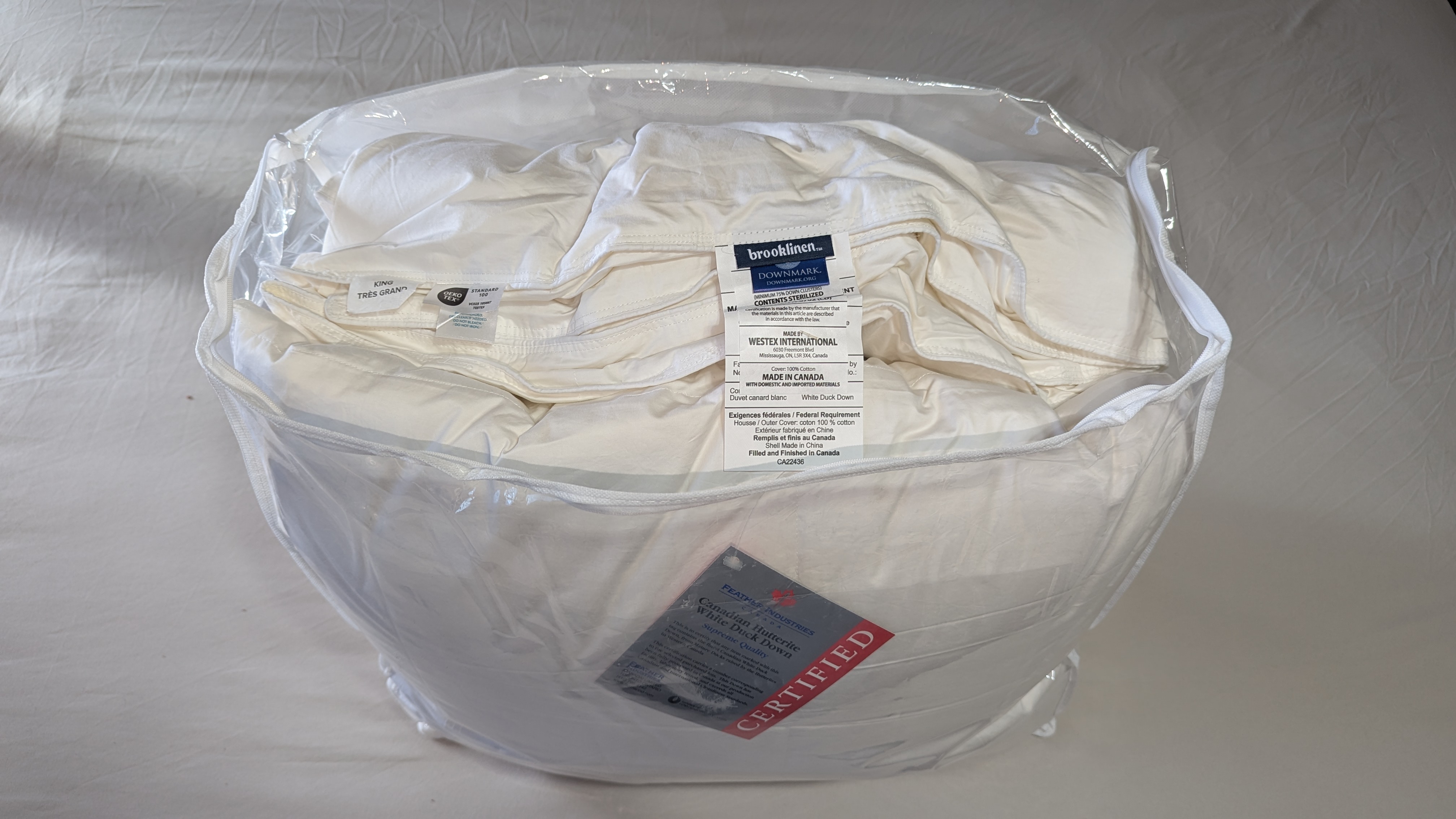 Brooklinen white down comforter in the package with tags attached