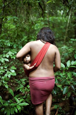 Awá woman with a baby in a sling.