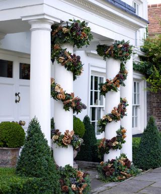 columns with Christmas garlands at front of house