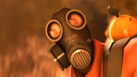 Meet the pyro screenshot showing close up of gas masked pyro character with flames reflected in eyepieces of mask