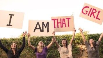 Woman Holding I Am That Girl Signs