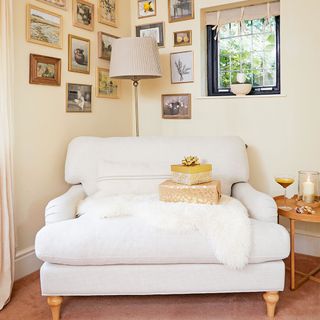 Neutral living room with armchair and pictures
