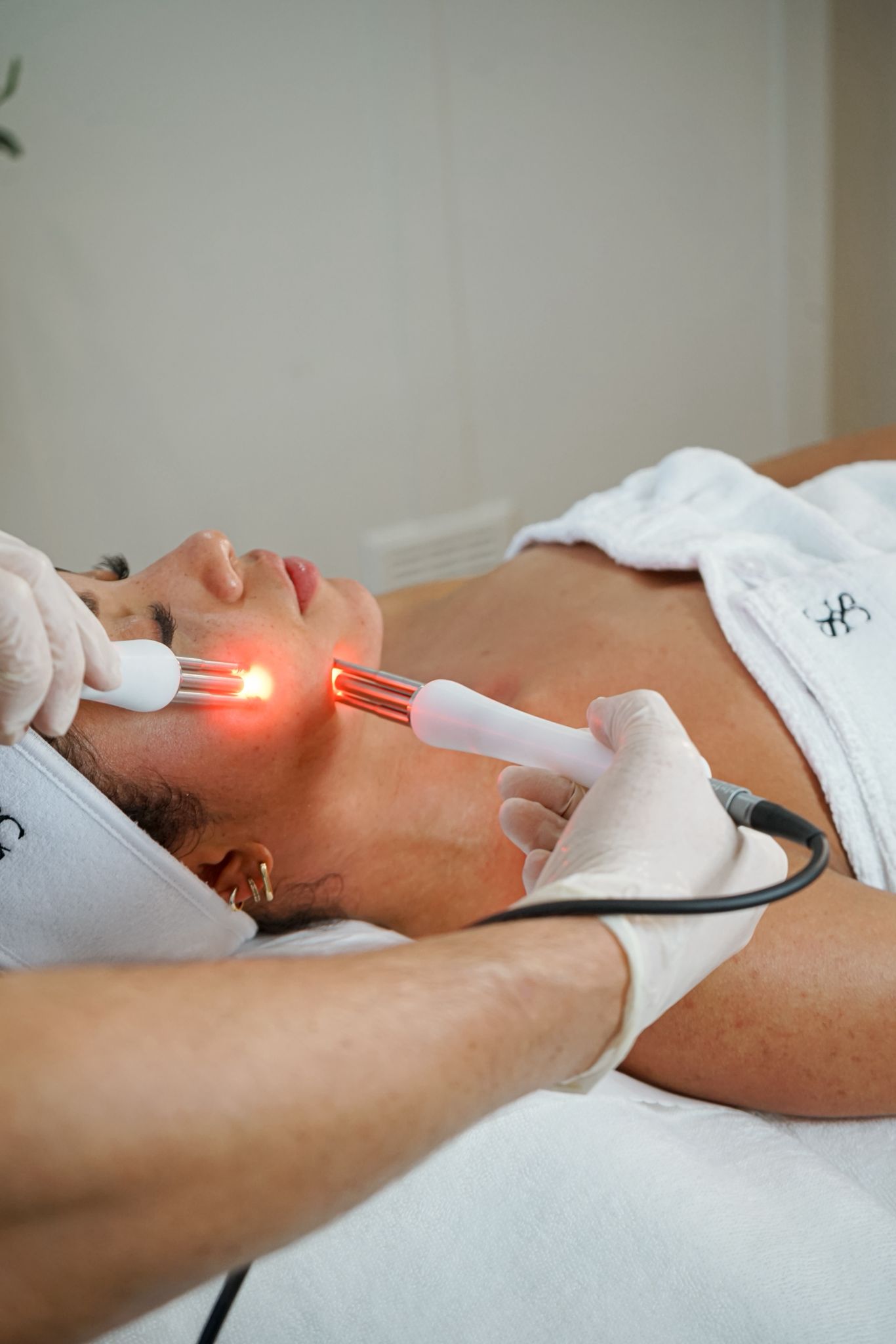 A woman inside the Shane Cooper clinic receiving a facial from Shane Cooper using the state of the art technology