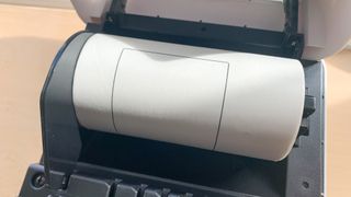 Close up of a Brother QL-1100c thermal printer on a desk