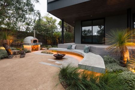 a backyard seating area with underlighting