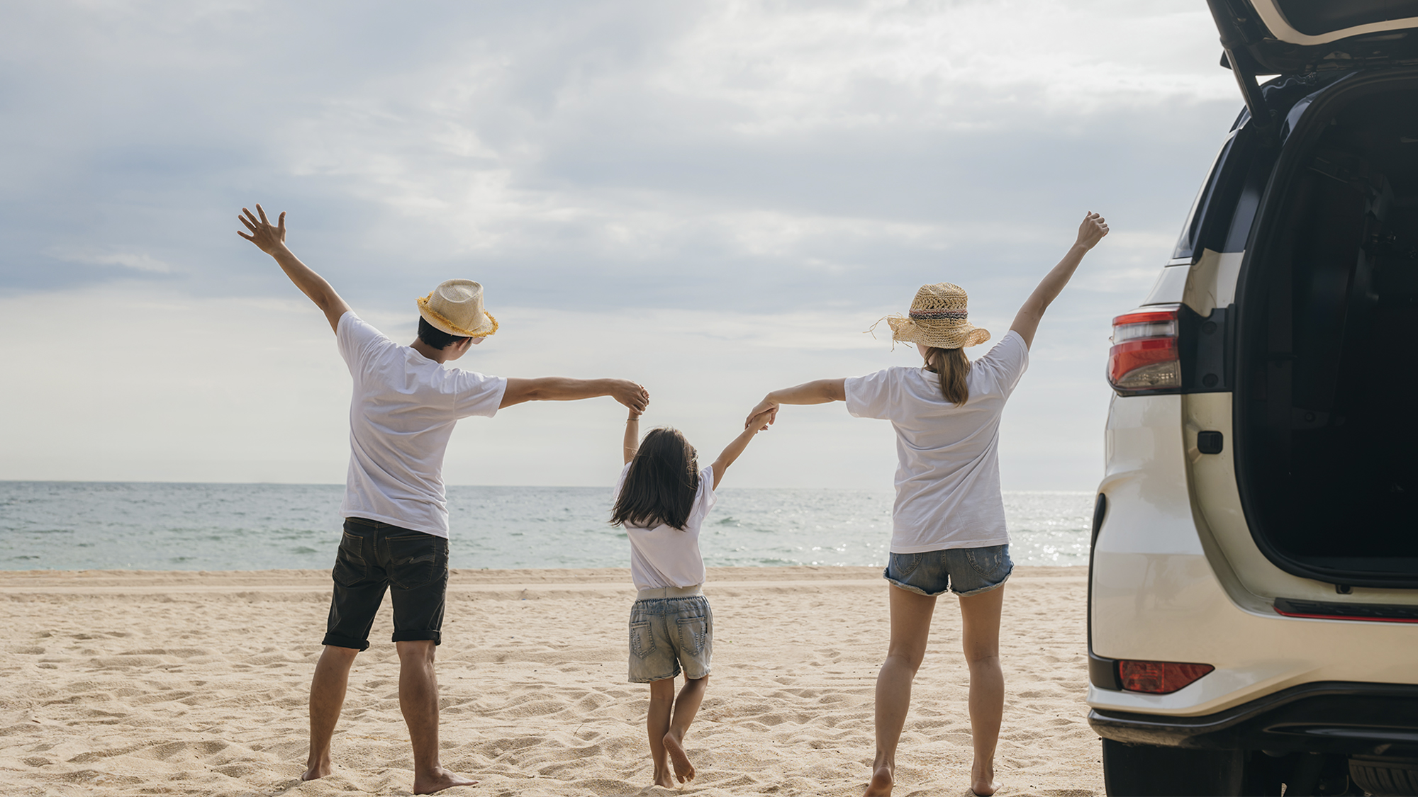 couple and their daughter at the beach