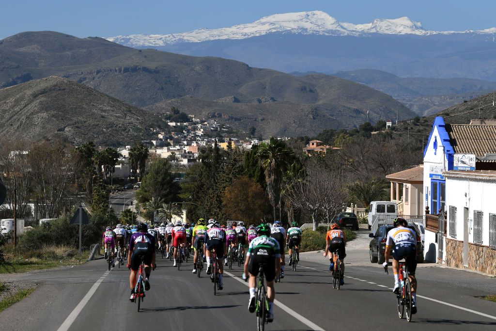 ROQUETAS DE MAR SPAIN FEBRUARY 14 The Peloton during the 34th Clsica de Almeria 2021 a 1833km race from Pueblo de Vicar to Roquetas de Mar Sierra Nevada Mountains Landscape ClasicaAlmeria21 on February 14 2021 in Roquetas de Mar Spain Photo by Tim de WaeleGetty Images