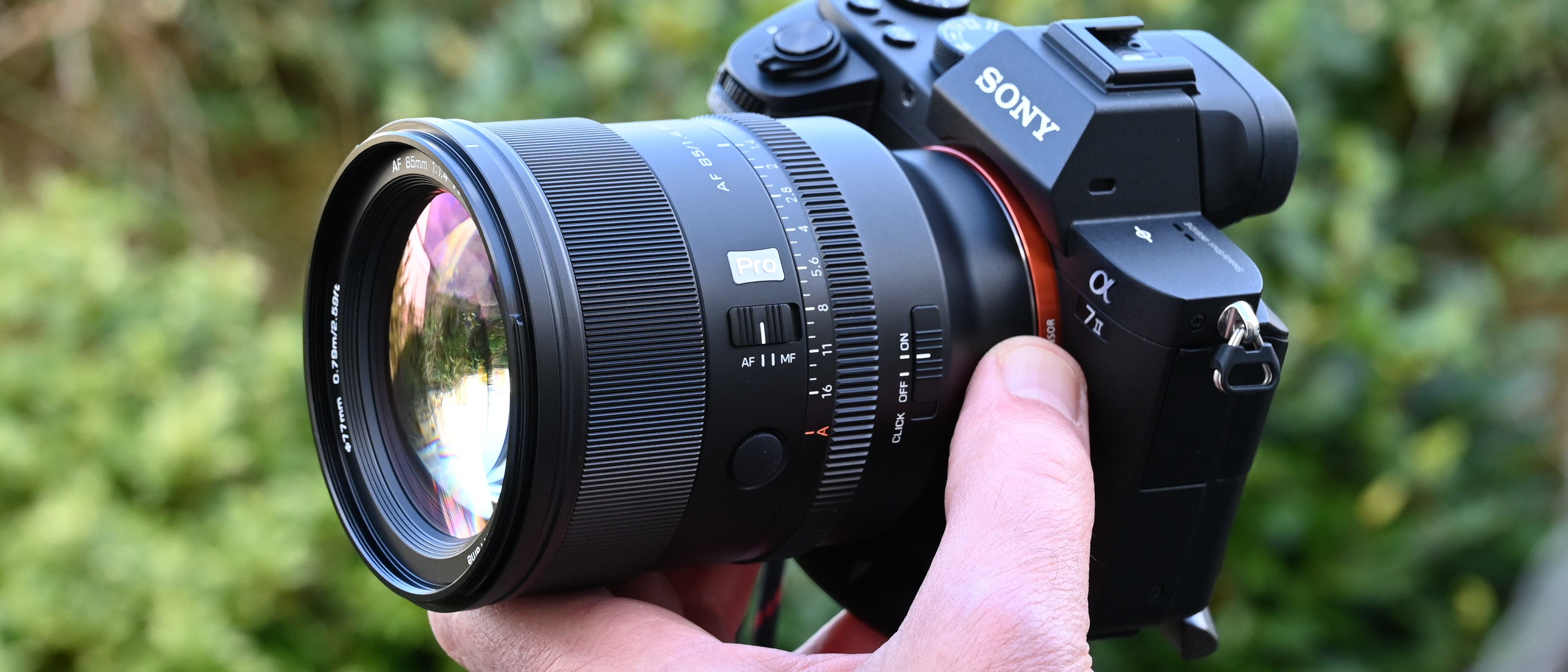 Viltrox AF 85mm f/1.4 Pro product shot, lens in hand