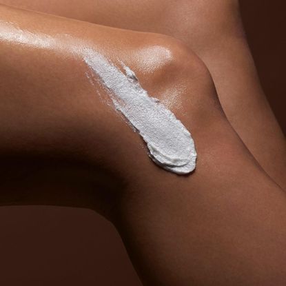 a womens knee with swatch of body scrub