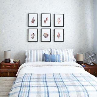 master bedroom with table fan and striped bedlinen