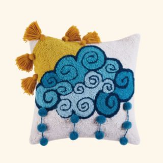 A cushion decorated with a sun and cloud 