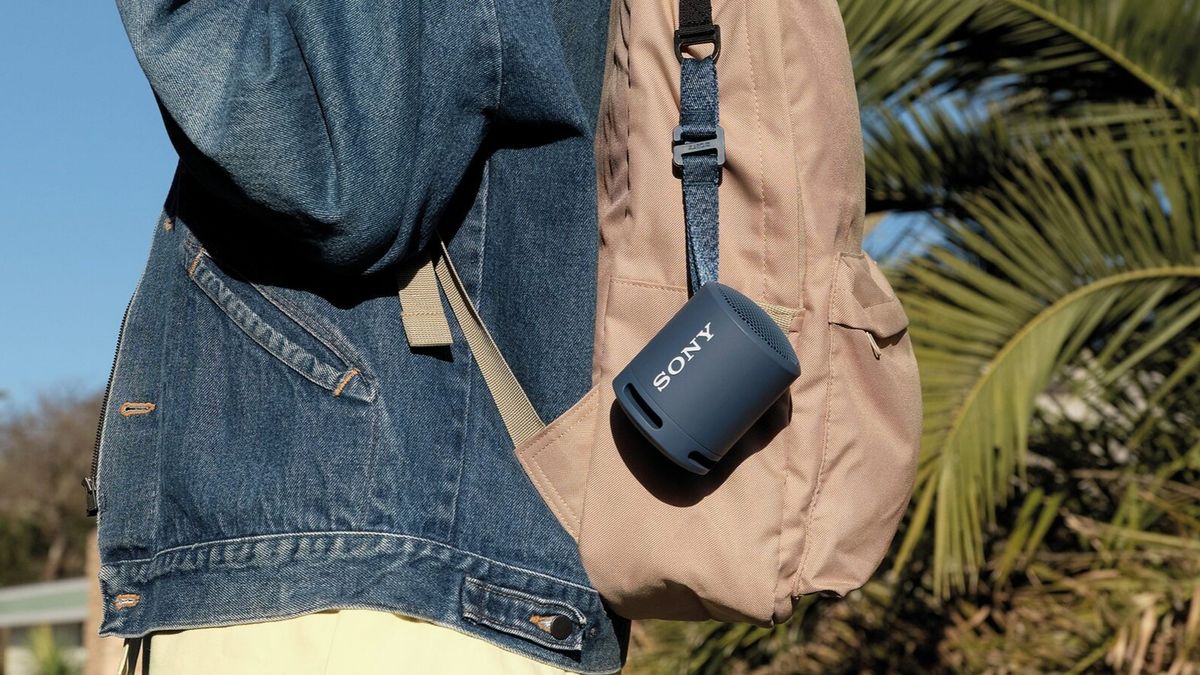 Sony SRS-XB13 Bluetooth speaker hanging from a backpack