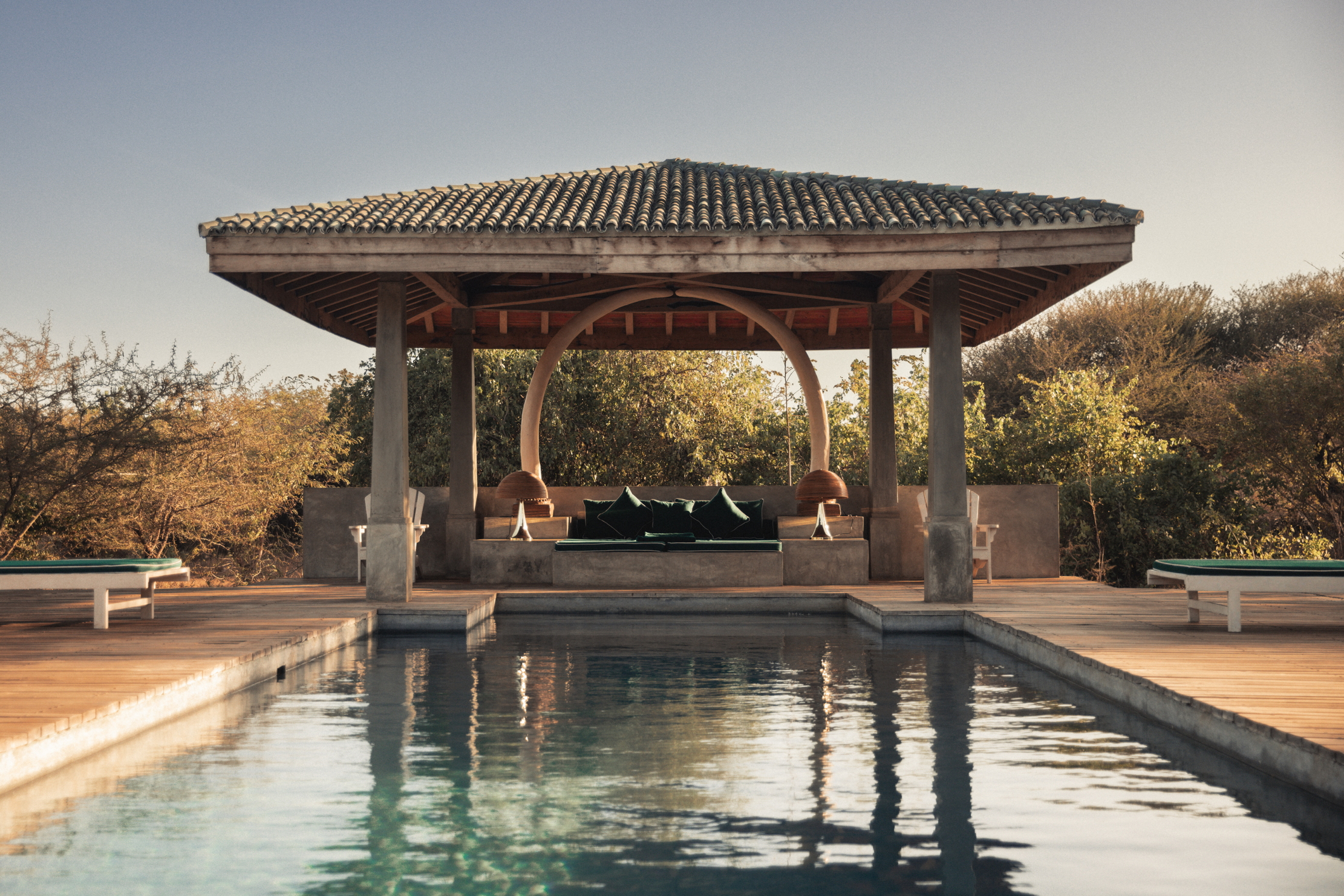 A pool with a pergola at the end