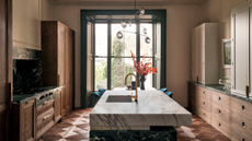 parquet floored kitchen with wooden cabinetry and a mixed marble kitchen island 