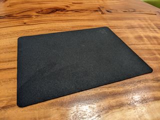 The Razer Goliathus Mobile Stealth Edition mouse pad on a wooden table