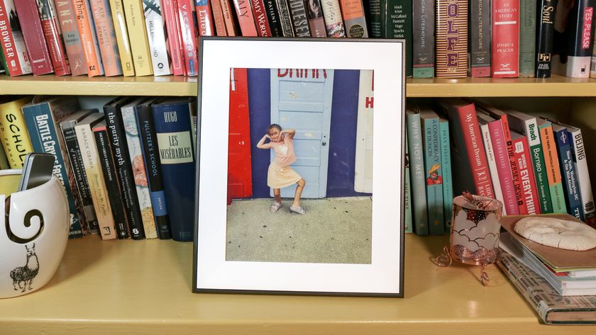 Aura Ink digital photo frame on a book shelf