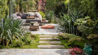 Garden with patio, outdoor sofa and modern flower bed ideas