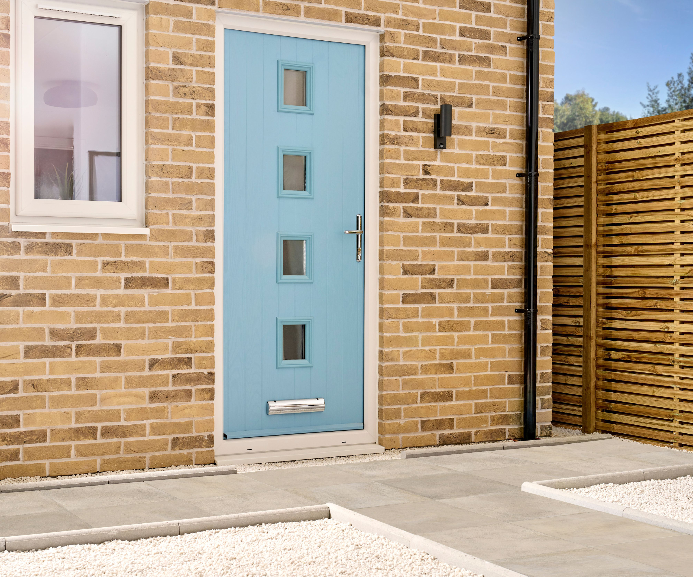 blue composite front door with 4 small glass sections in vertical line down centre of door