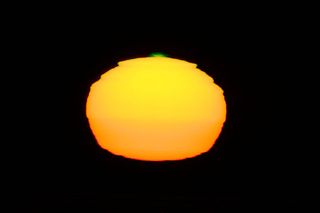 A green flash of the sun appears to observers upon Cerro Paranal. A green flash is an optical phenomenon in which a tiny portion of the sun briefly appears to turn green at sunset or sunrise.