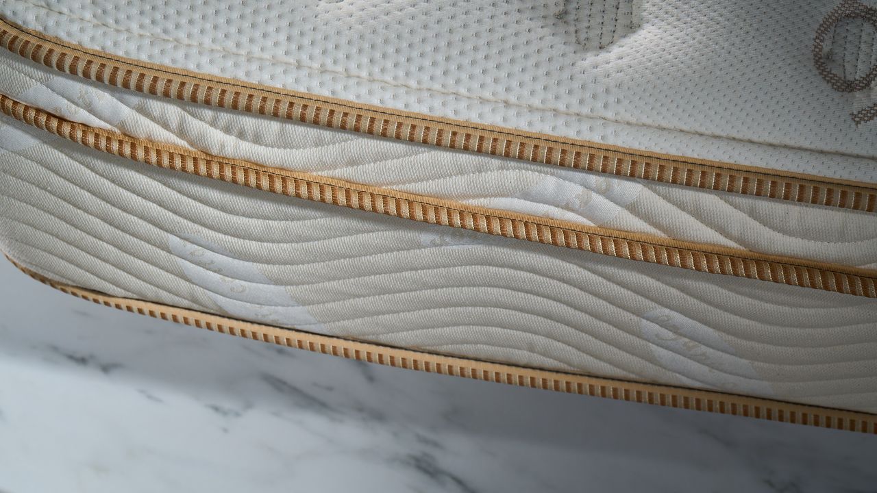 The golden rails running along the side of the Saatva Classic Mattress photographed during testing