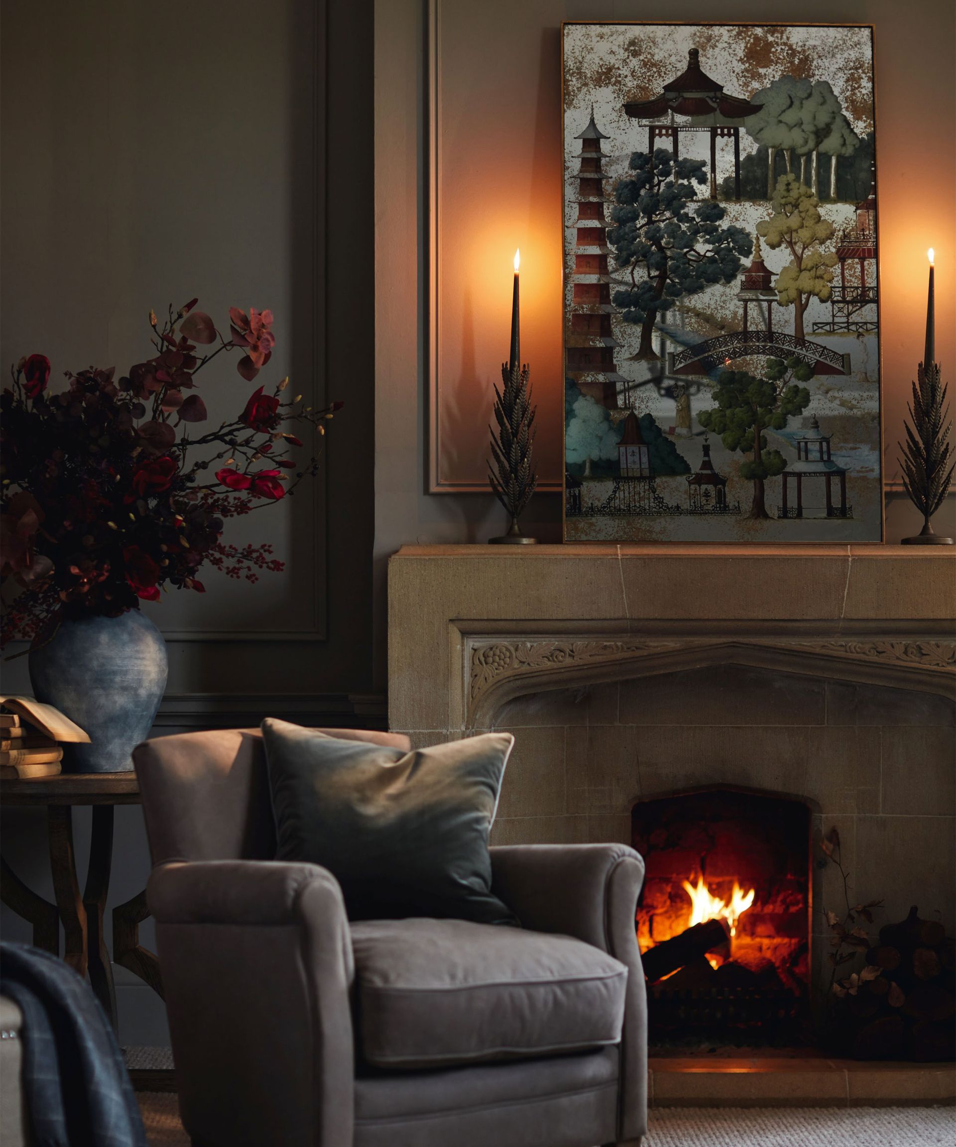 Cozy living room with fireplace, artwork decorated mantel and candles.