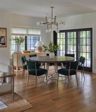 dining room round table black chairs and steel framed windows