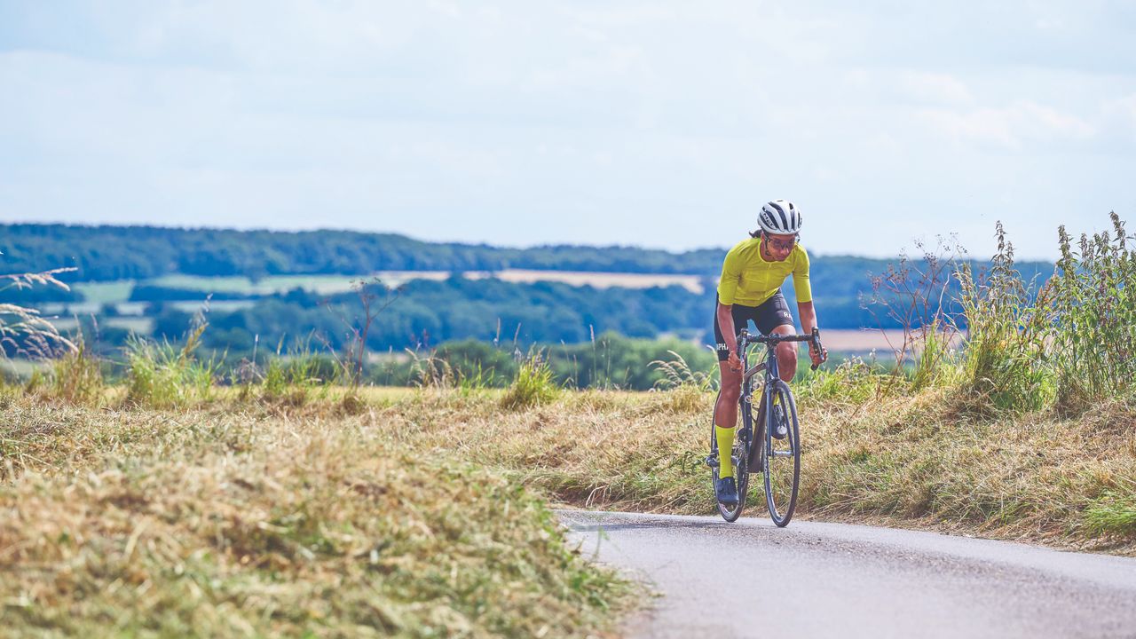 Female cyclist rides solo in summer training kit