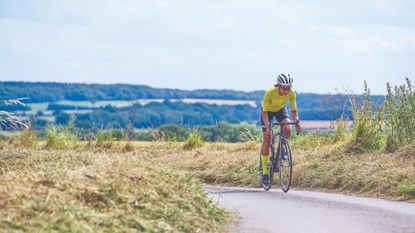 Female cyclist rides solo in summer training kit