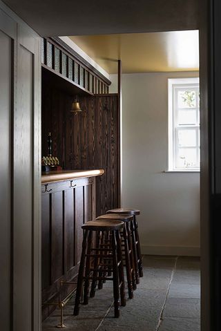 Bar area of the Kinneuchar Inn, Fife, UK with wooden paneling and wooden stools