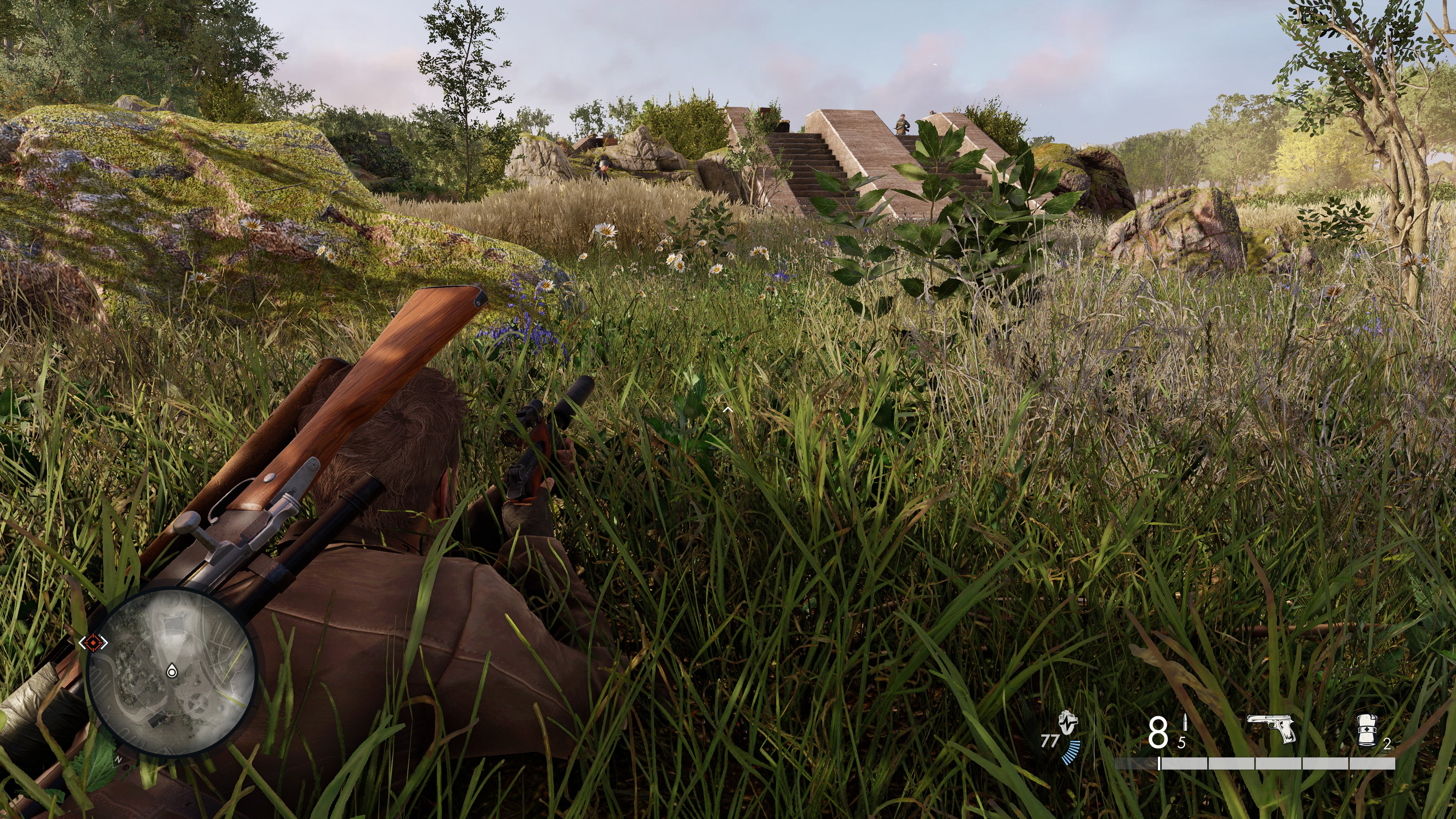 The protagonist of Sniper Elite: Resistance crouches in some shrubbery.