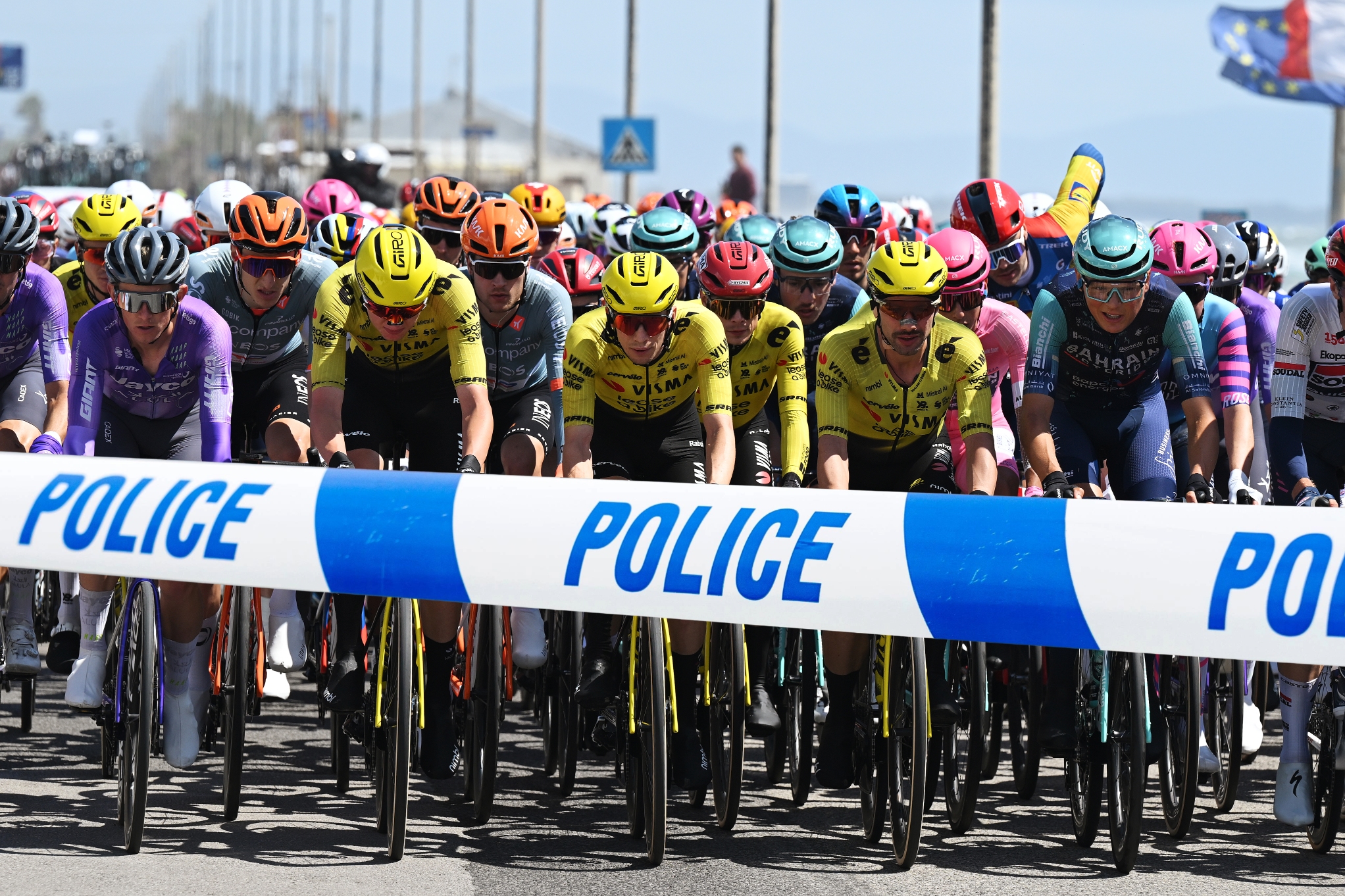 The peloton at the Giro d'Italia with police tape across it