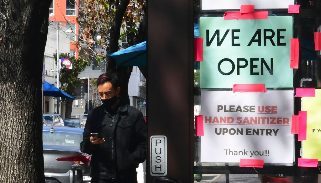 A &amp;quot;We Are Open&amp;quot; sign is seen on the side of a restaurant as indoor dining reopens in Los Angeles, on March 15, 2021.