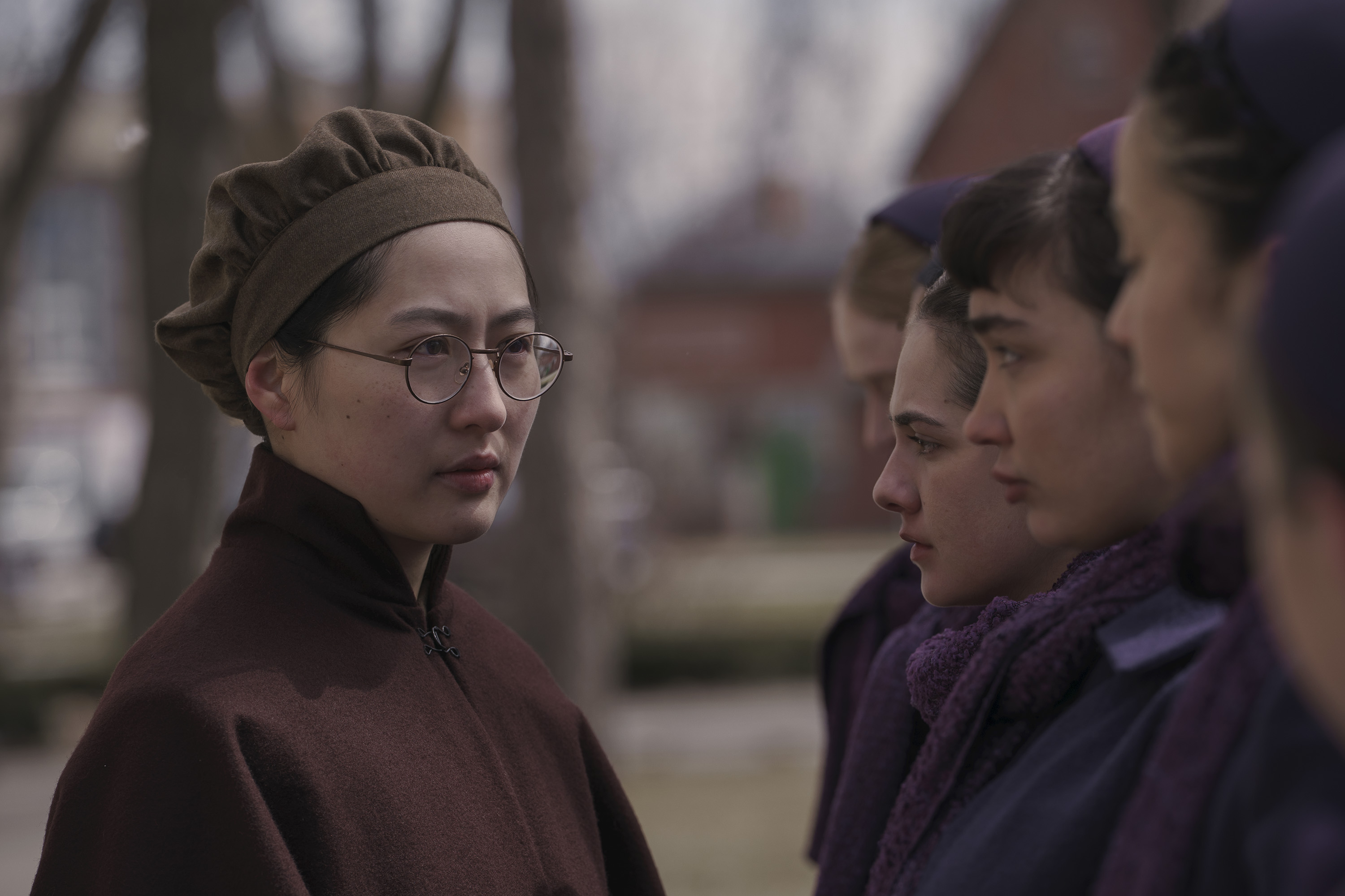 l-r Mabel Li as Aunt Vidala, Mattea Conforti as Becka, and Rowan Blanchard as Shunammite, in Hulu's 'The Testaments'