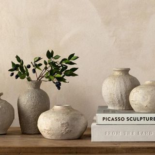 Five ceramic vases from McGee & Co. on a wooden shelf