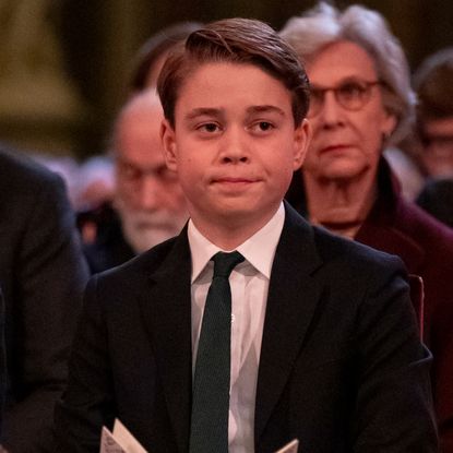 Prince George wearing a suit sitting in church