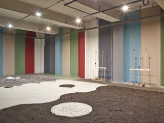 A room with multi-coloured rectangular blocks painted on the walls. Brown, white, greyy