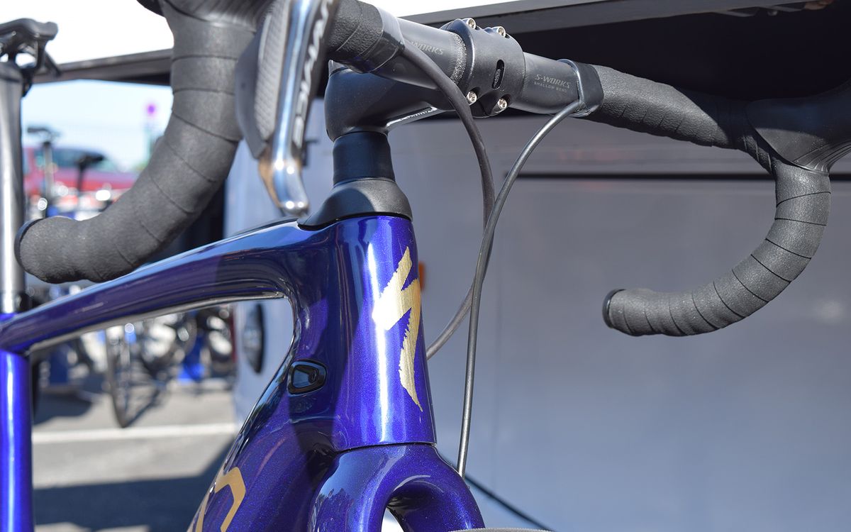 Gold logos are overlaid onto a deep blue finish