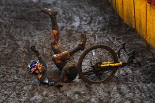 BOOM BELGIUM DECEMBER 04 Wout Van Aert of Belgium and Team Jumbo Visma falls on a muddy sector during the 7th Superprestige Cyclocross Boom 2021 Mens Elite SPBoom Superprestige2022 on December 04 2021 in Boom Belgium Photo by Luc ClaessenGetty Images
