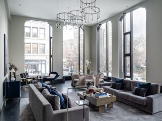 A bright living room with floor-to-ceiling windows and statement furniture