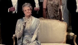 Dame Maggie Smith sits on a bench in Downton Abbey: The Motion Picture.