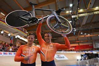 Silver medallist Netherlands' Jeffrey Hoogland (L) and gold medallist Netherlands' Harrie Lavreysen celebrate after the men's Sprint race of the UCI Track Cycling World Championships in Ballerup, Denmark, on October 20, 2024. (Photo by Jonathan NACKSTRAND / AFP)