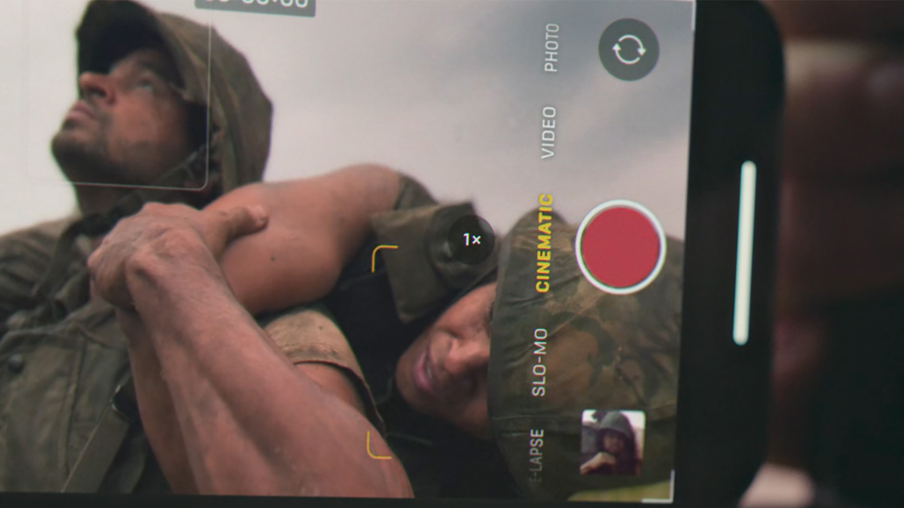 A phone showing a video of two soldiers in battle