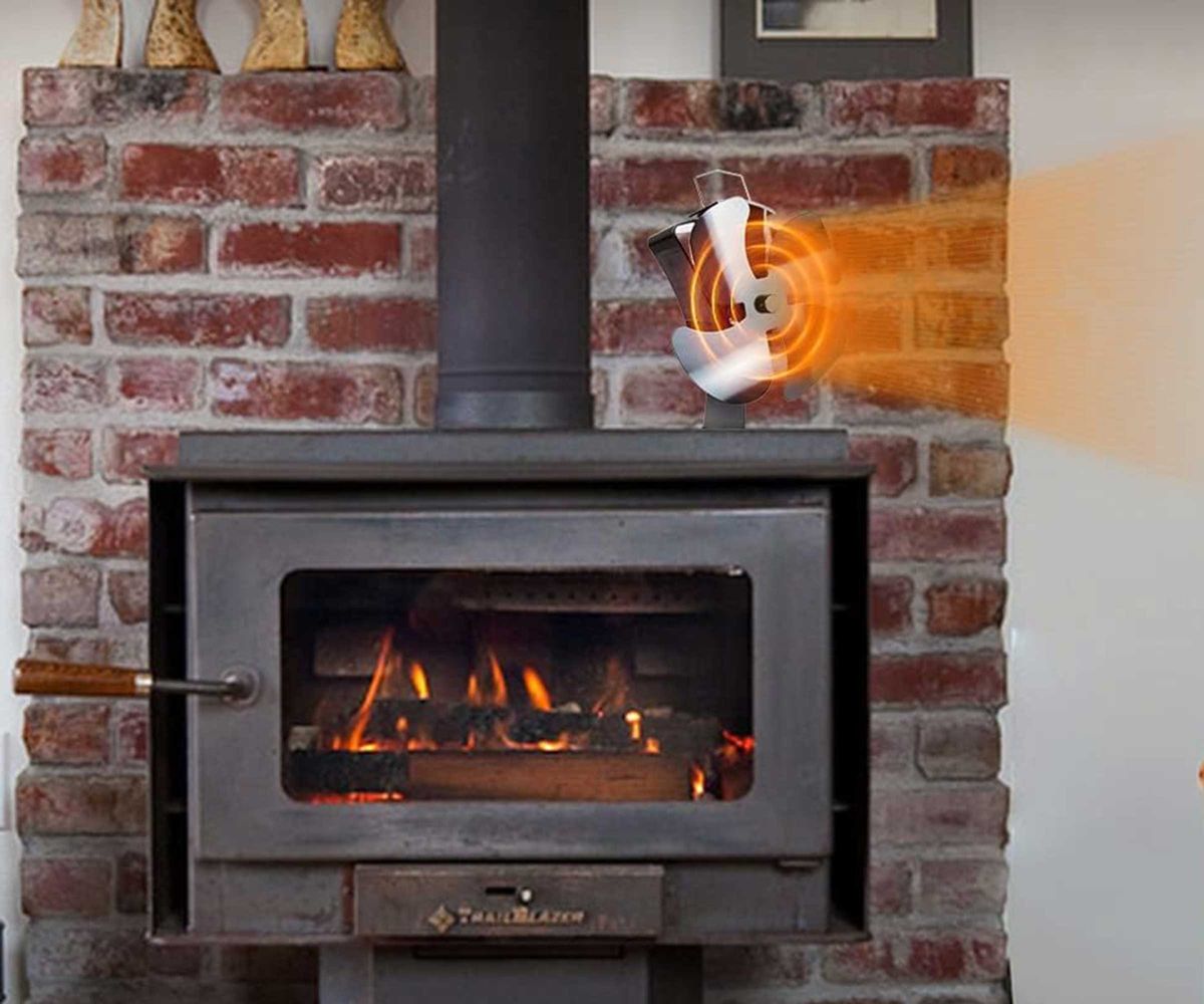 Tomersun stove fan on top of a wide log burning stove